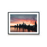 Frankfurt Skyline Poster im Querformat. Roter Himmel zum Sonnenuntergang, Spiegelung im Main.  Bild mit weißen umlaufenden Rand. Poster fertig gerahmt.