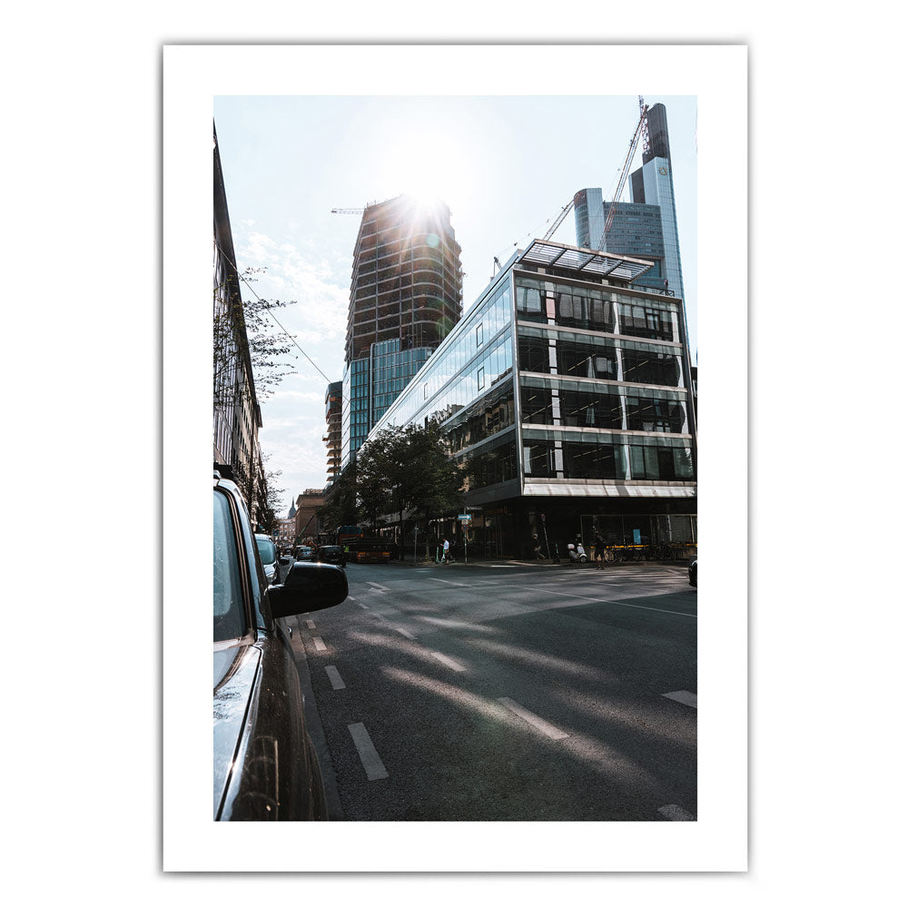 Frankfurt Poster von den Straßen Frankfurts im Street Style. Sonnenstrahlen hinter der Frankfurter Skyline. Bild mit weißen umlaufenden Rand.
