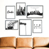 Frankfurt Poster Set mit 6 Bildern. 4 Illustrierte Bilder in schwarz weiß und 2 FFM Spruch Bilder. Bilder im schwarzen Rahmen über einem braunen Sofa.